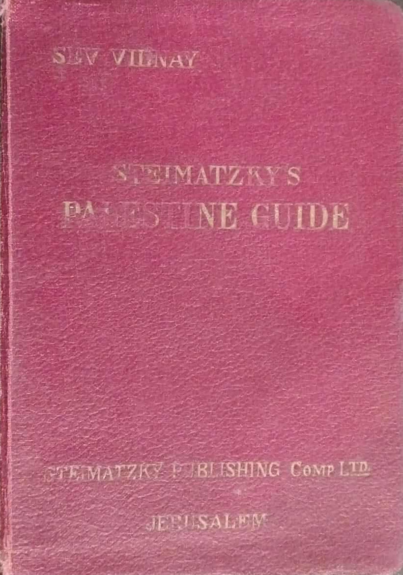 Red book with gold text on a dark surface
