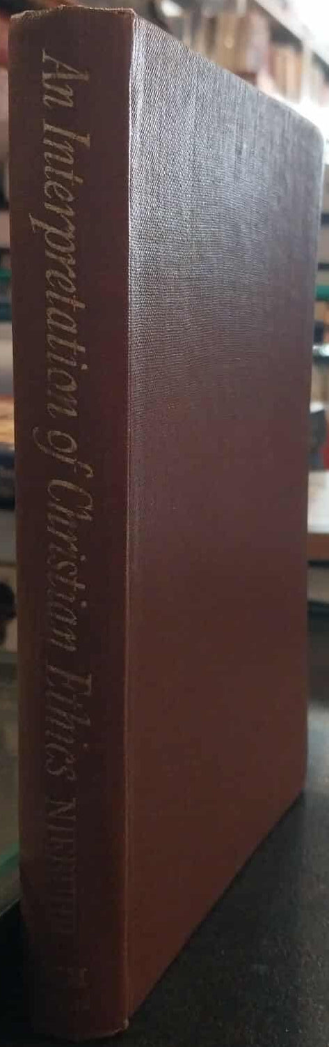 Red book titled 'An Interpretation of Christian Truth' on a shelf with blurred background