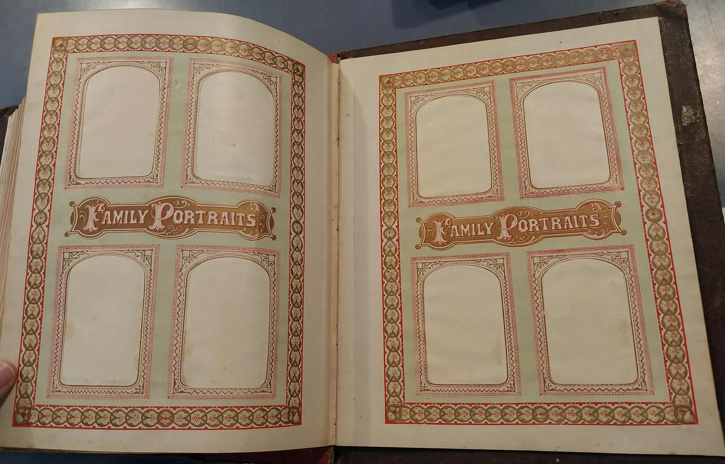 Open album with 'Family Portraits' design on a dark surface