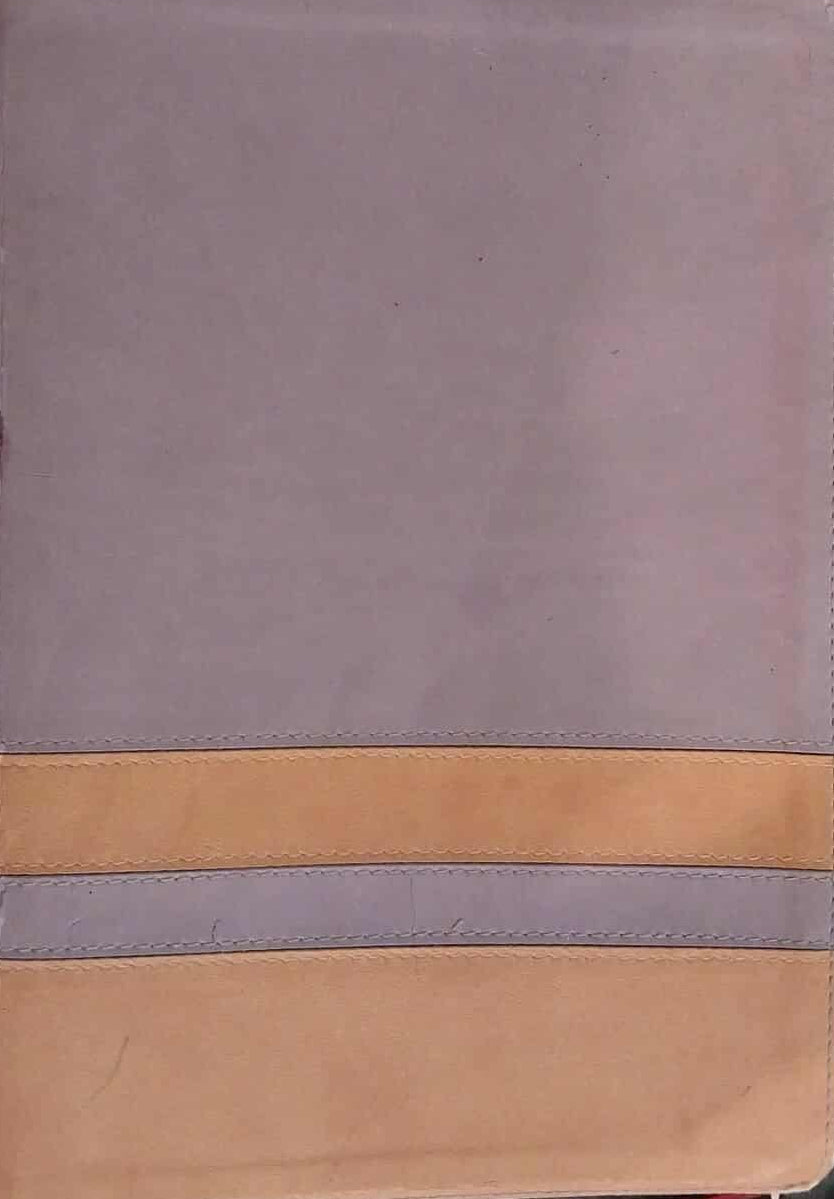 Two-tone notebook with gray top and brown bottom on a dark surface