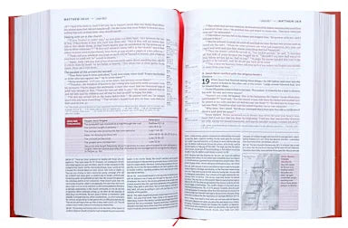Open book with red binding on a white background