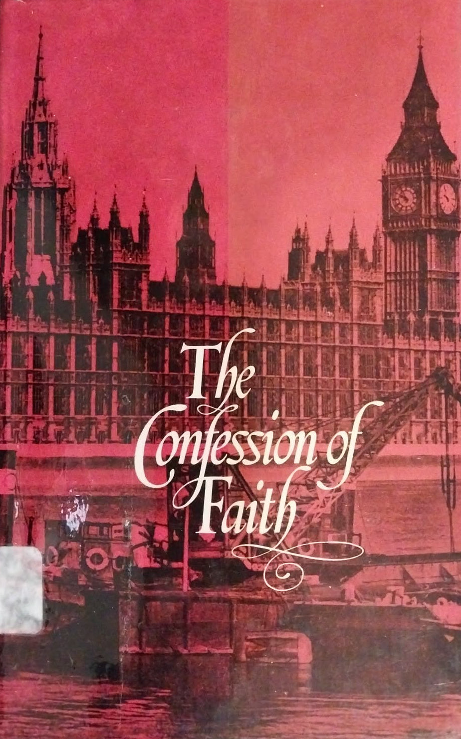 Book titled 'The Confession of Faith' with a red cover featuring architectural designs.