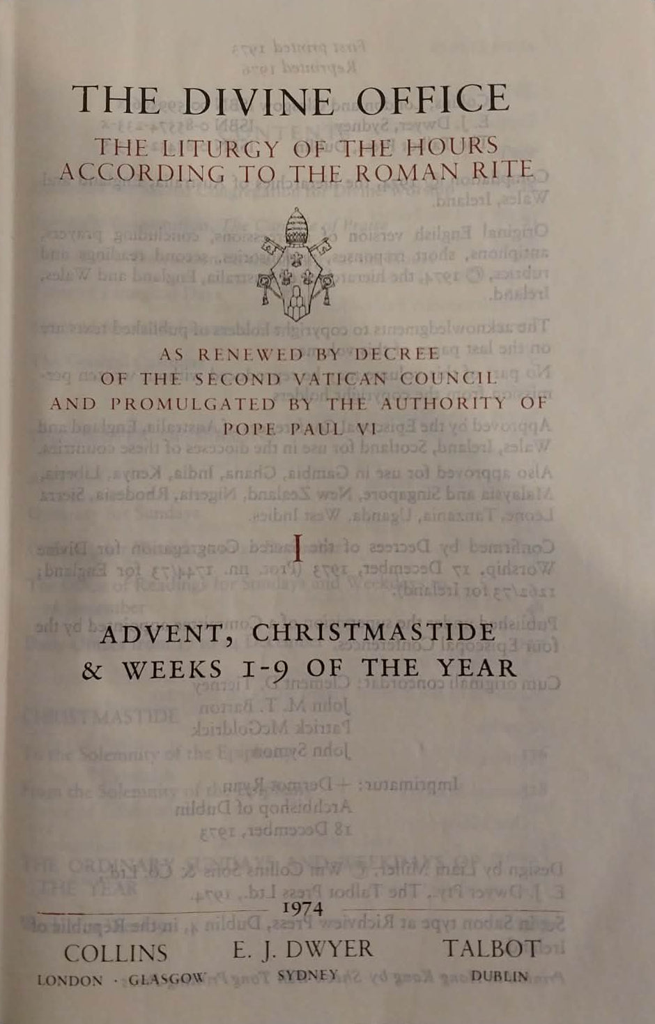 Open book titled 'The Divine Office' with text on a dark background