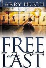 Book cover of 'Free at Last' by Larry Hugh with a man and woman embracing.