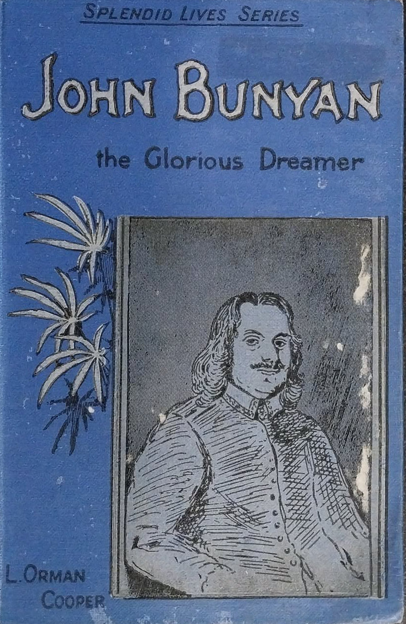 Vintage hardcover book of John Bunyan's 'The Glorious Dreamer' from the Splendid Lives Series, featuring a blue cover with a black-and-white portrait illustration and text, photographed on a dark brown textured surface.