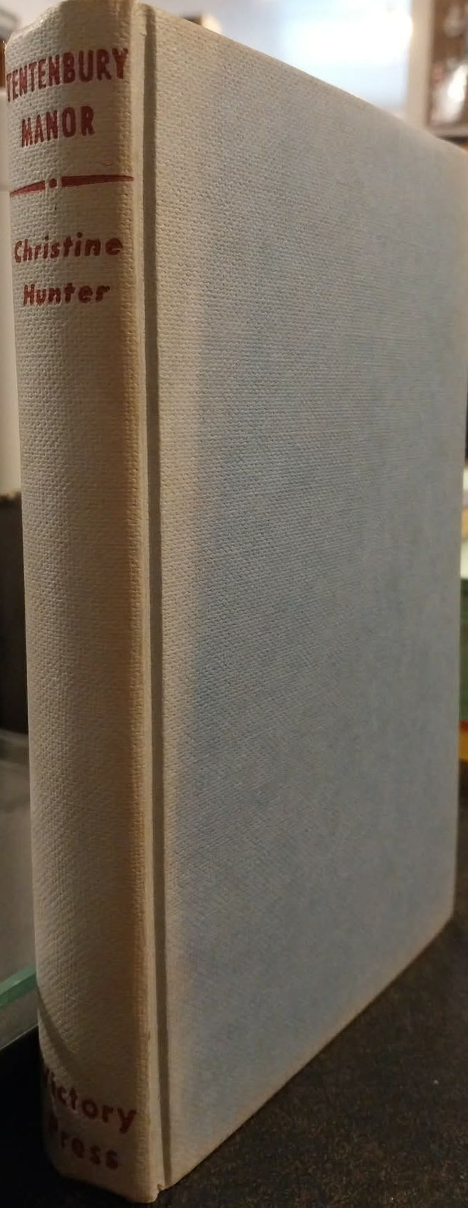 Book titled 'Penkenbury Manor' by Christine Hunter on a shelf.