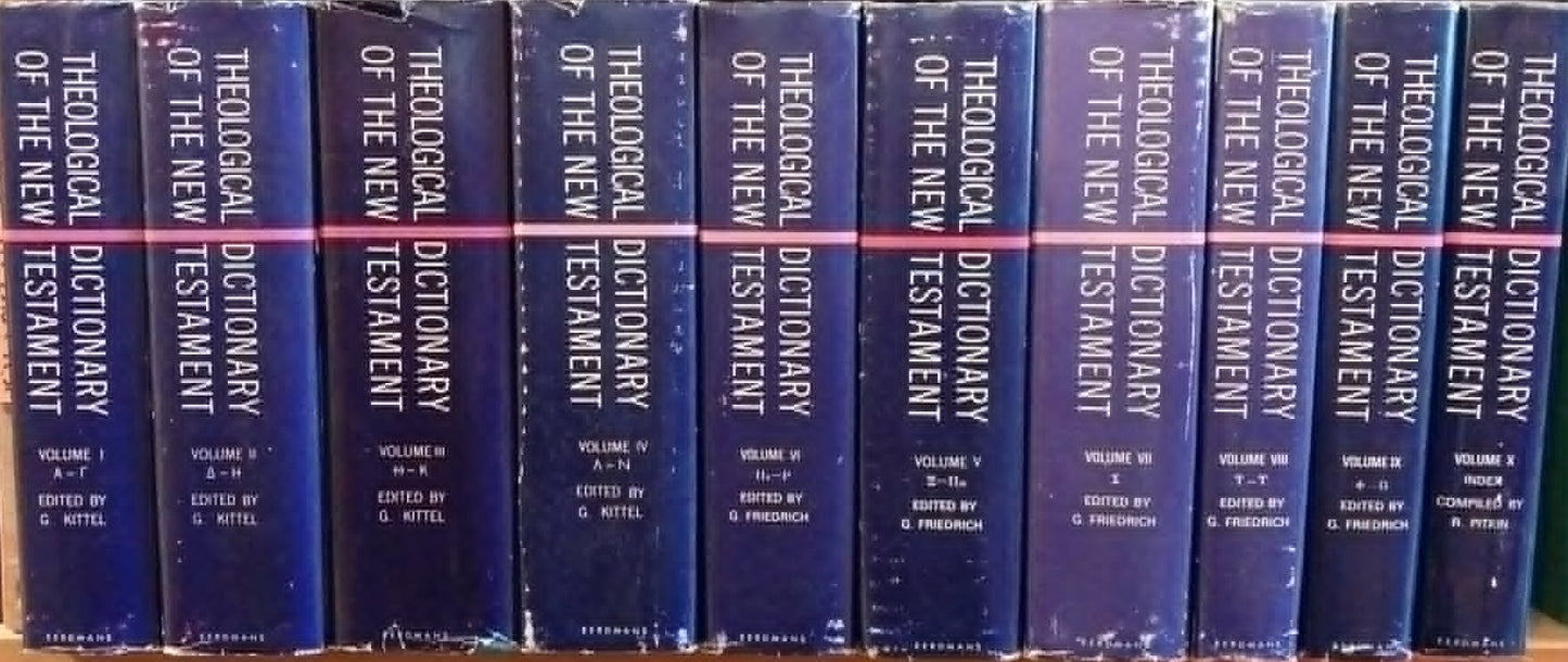 Row of blue books titled 'Theological Dictionary of the New Testament' on a shelf.