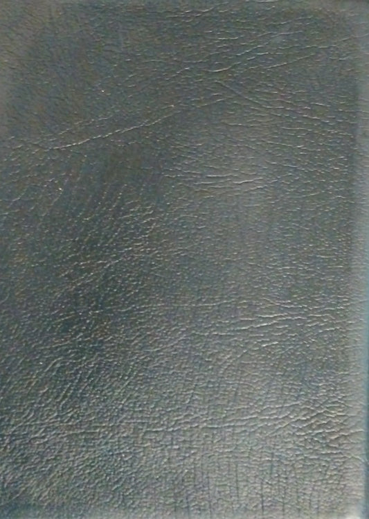 A dark gray textured faux-leather notebook or binder cover lying on a brown wooden surface.