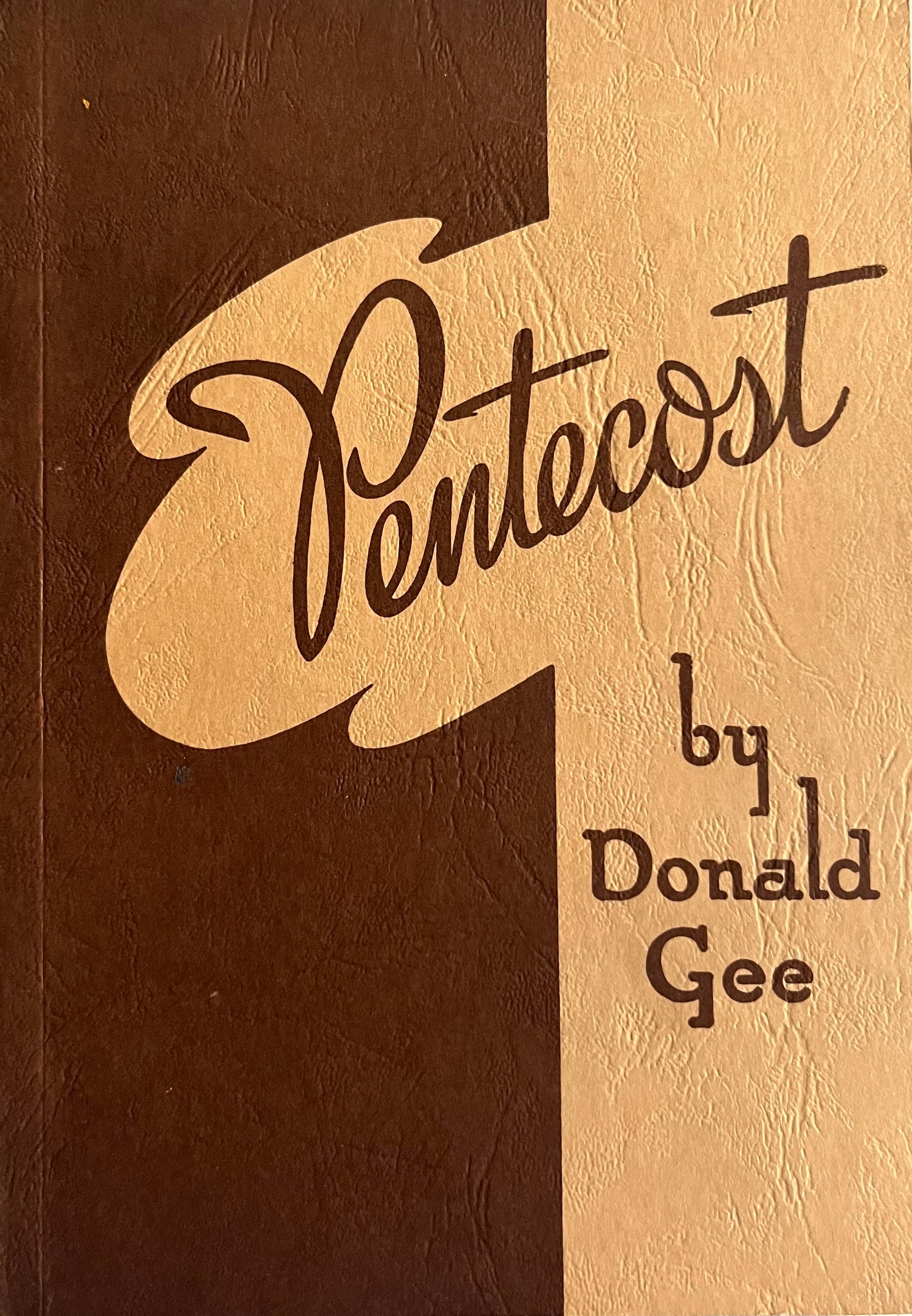 Wooden block with 'Pentecost by Donald Gee' book on background