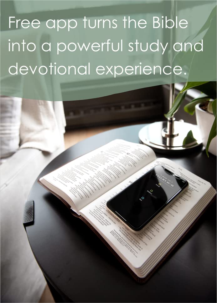 Open book with a smartphone on top, placed on a table with a blurred background.