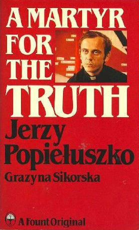 The front cover of the Polish book 'A Martyr for the Truth' by Jerzy Popieluszko, featuring a solid red background with bold cream and black text and a small portrait photo of the author.