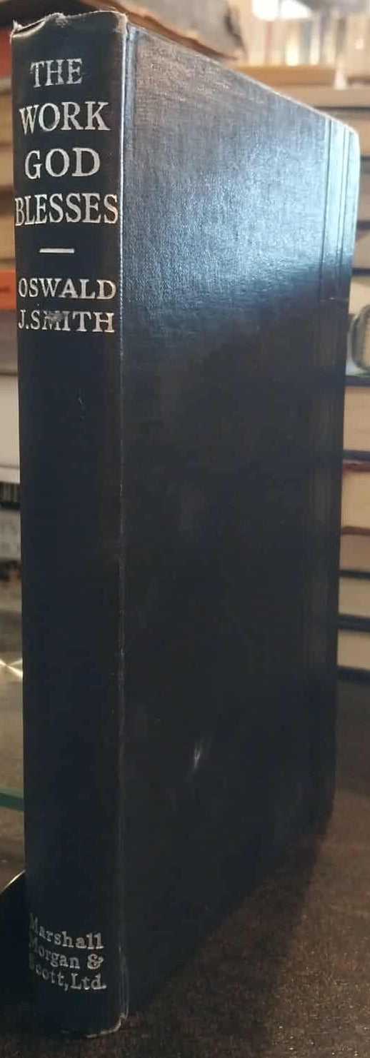 Book titled 'The Work God Blesses' by Oswald Chambers on a stack of books.