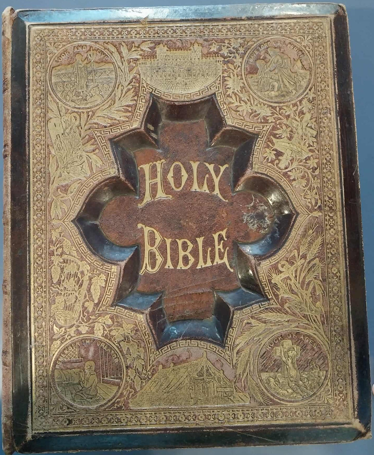 Vintage Holy Bible with ornate cover on a blue background