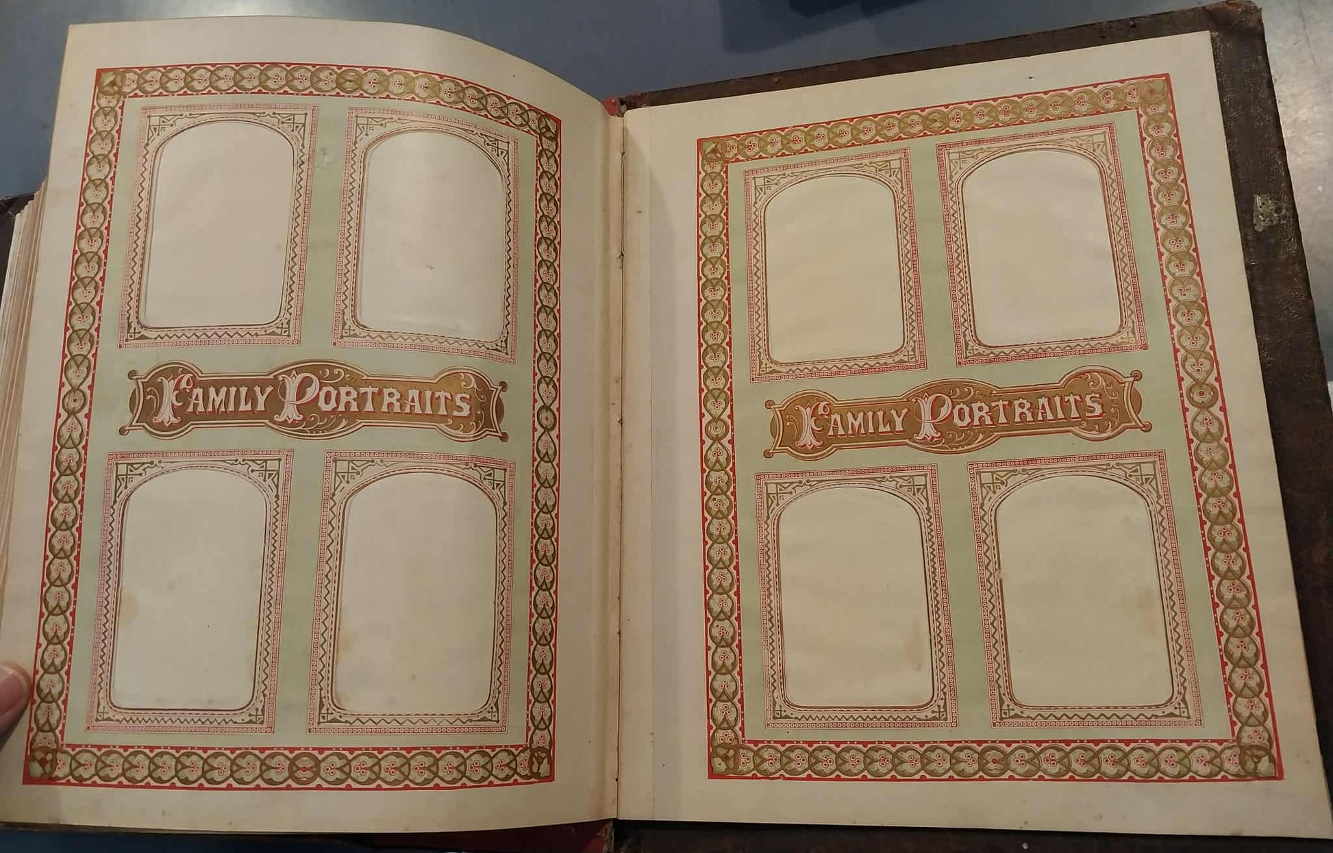 Open album with 'Family Portraits' design on a dark surface