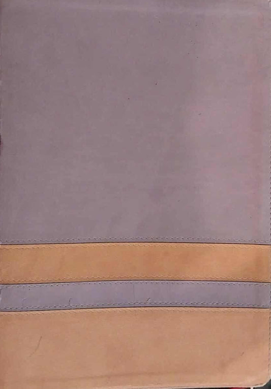 Two-tone notebook with gray top and brown bottom on a dark surface