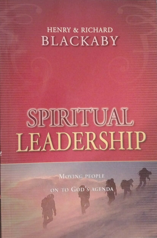 Book titled 'Spiritual Leadership' by Henry and Richard Blackaby on a dark surface