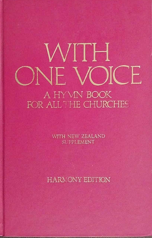 Pink hymn book titled 'With One Voice' on a dark surface