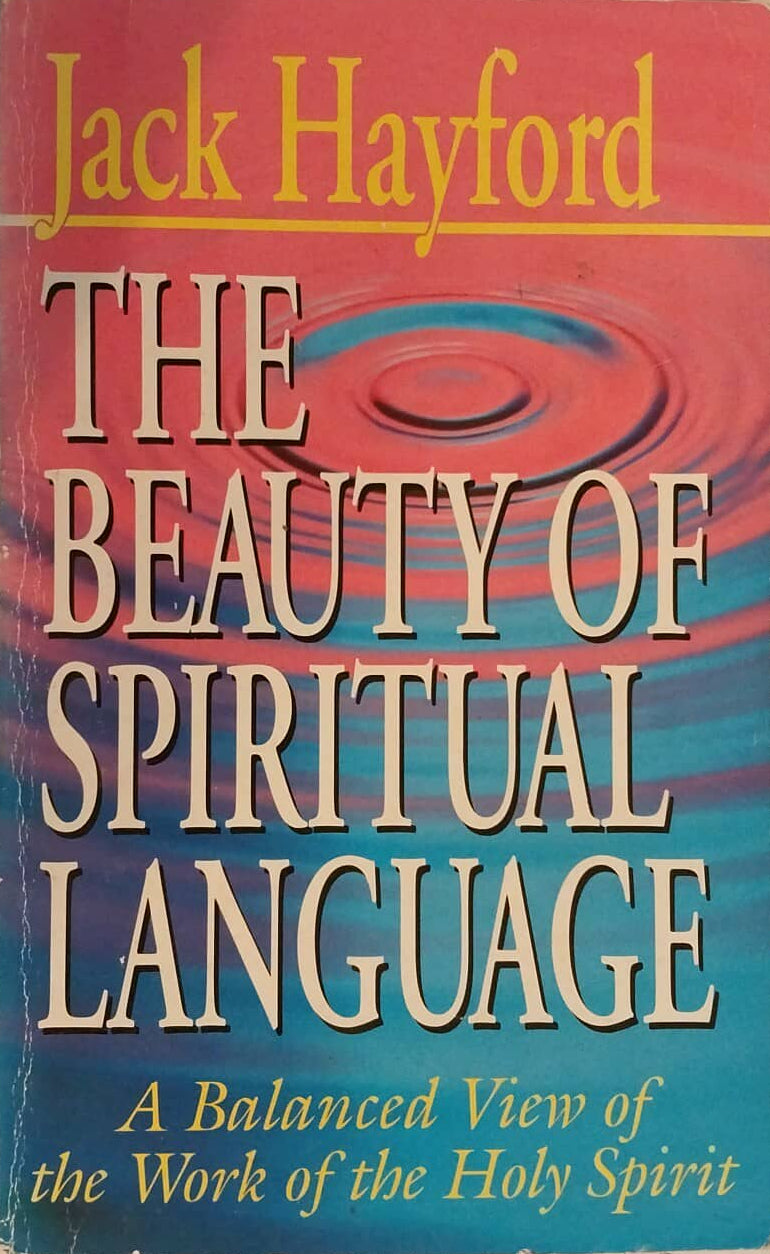 Book titled 'The Beauty of Spiritual Language' by Jack Hayford on a surface with another book in the background.