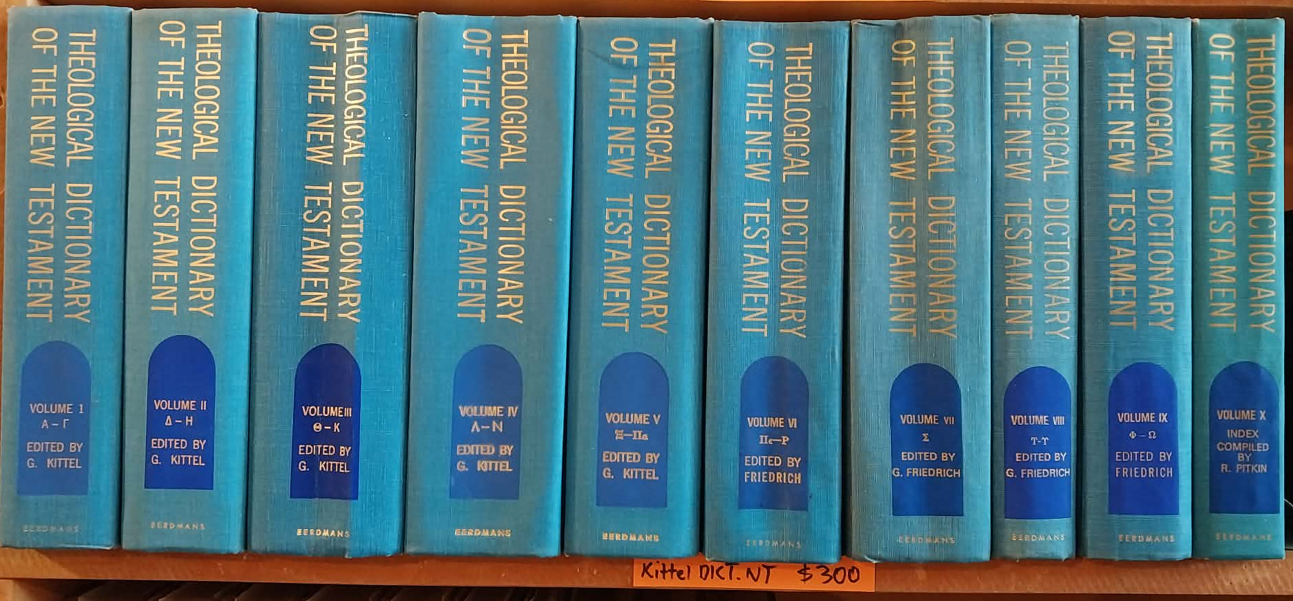 Set of blue books titled 'Theological Dictionary of the New Testament' on a shelf.
