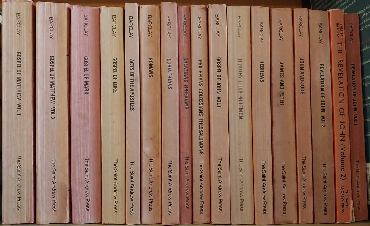 Row of books on a shelf with visible spines