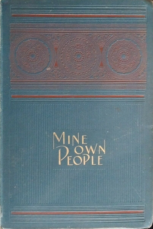 Blue book titled 'Mine Own People' on a dark surface