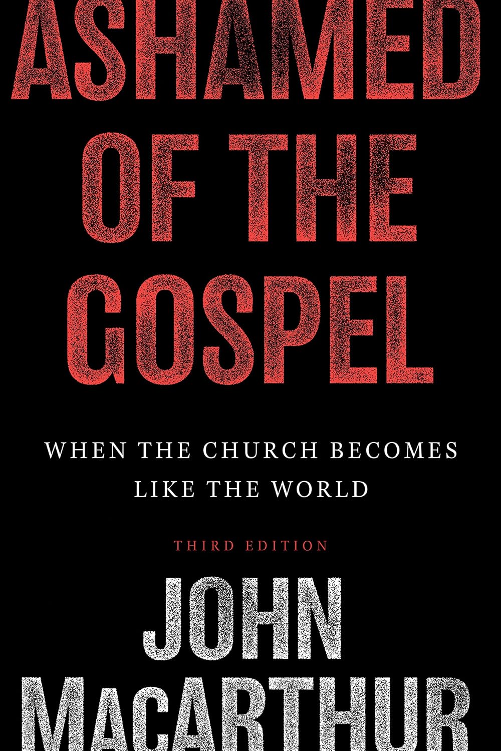 Book cover of 'Ashamed of the Gospel' by John MacArthur with red and white text on a black background.