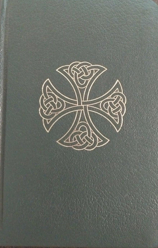 Green notebook with a Celtic cross design on a brown surface