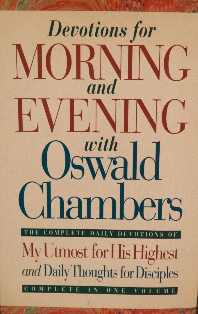 A hardcover book titled 'Devotions for Morning and Evening with Oswald Chambers' on a dark background. The cover is cream-colored with large red and dark blue text and a decorative multicolor border at the top and bottom.