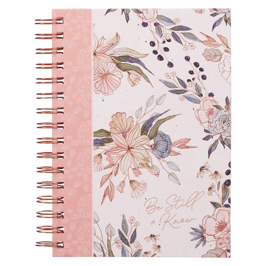 Floral notebook with pink spine and 'Be Still & Know' text on a white background