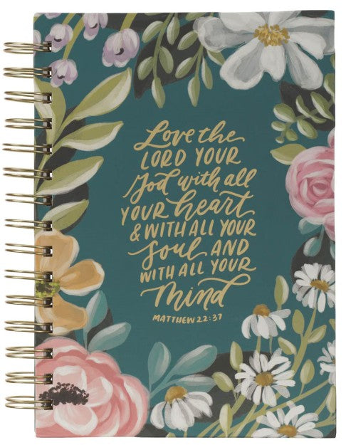Notebook with floral design and inspirational quote on a teal background
