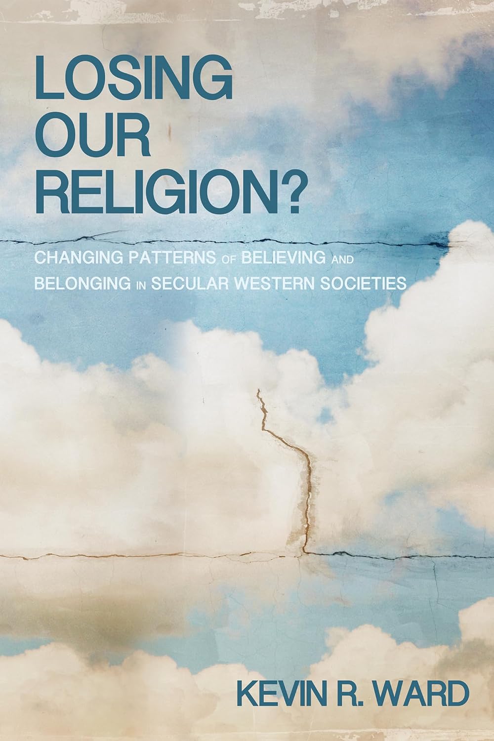 Book cover for 'Losing Our Religion?' by Kevin R. Ward, featuring a sky-and-cloud background with a vertical crack running down the center and blue title text.