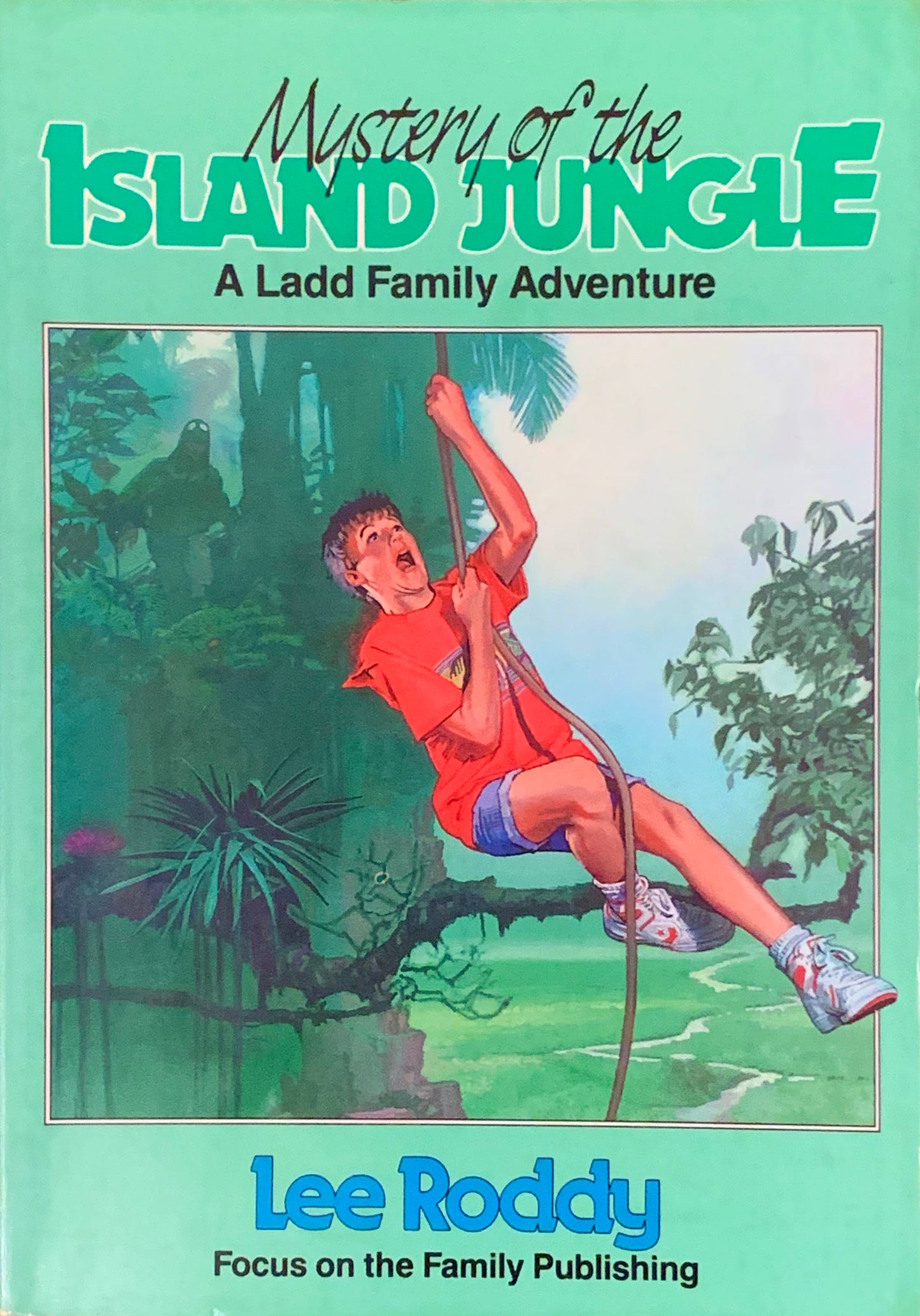 Front cover of the book 'Mystery of the Island Jungle: A Ladd Family Adventure' by Lee Roddy, featuring a light green background and an illustration of a boy climbing down a rope in a jungle scene.