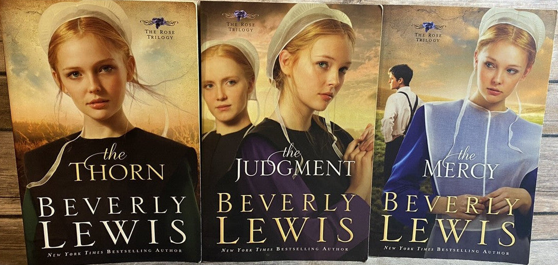 Three books by Beverly Lewis on a wooden surface