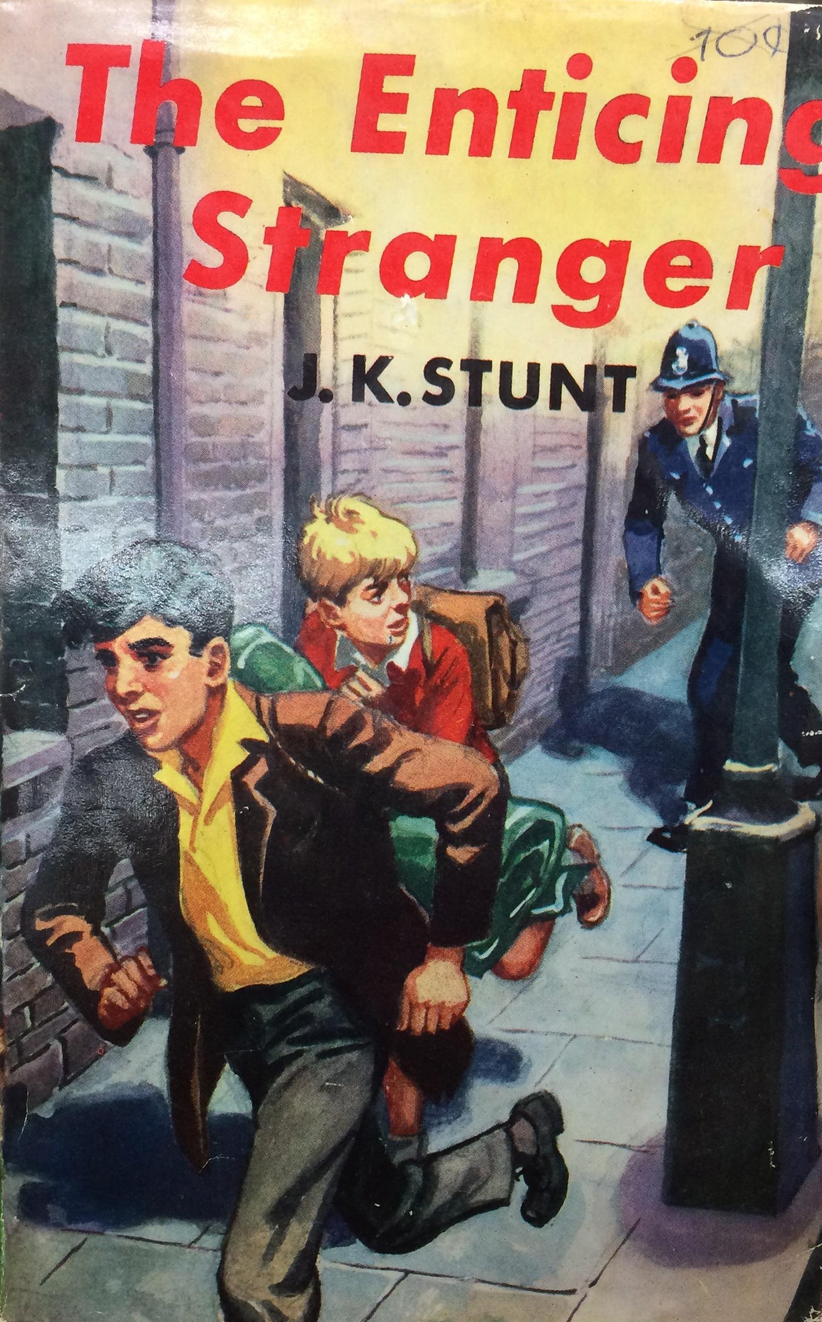 Book titled 'The Enticing Stranger' by J.K. Stunt held in a hand with a library background.