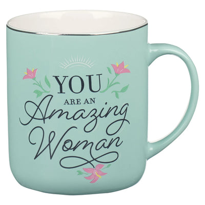 Mint green mug with 'You are an Amazing Woman' text and floral designs on a white background