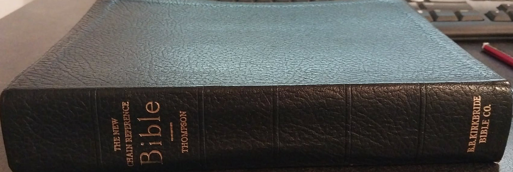 Thomson Reuters Bible on a desk with office equipment in the background