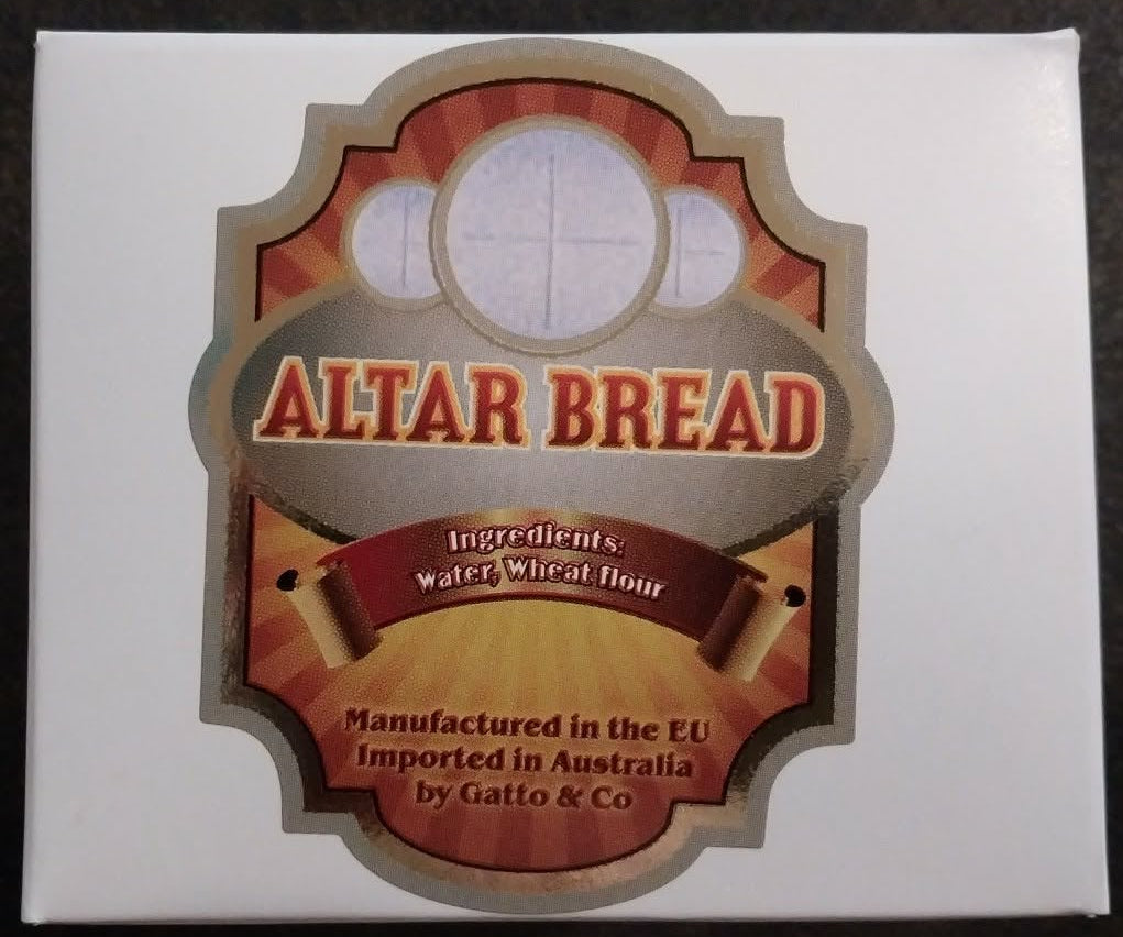 Box of Altar Bread with decorative label on a dark background