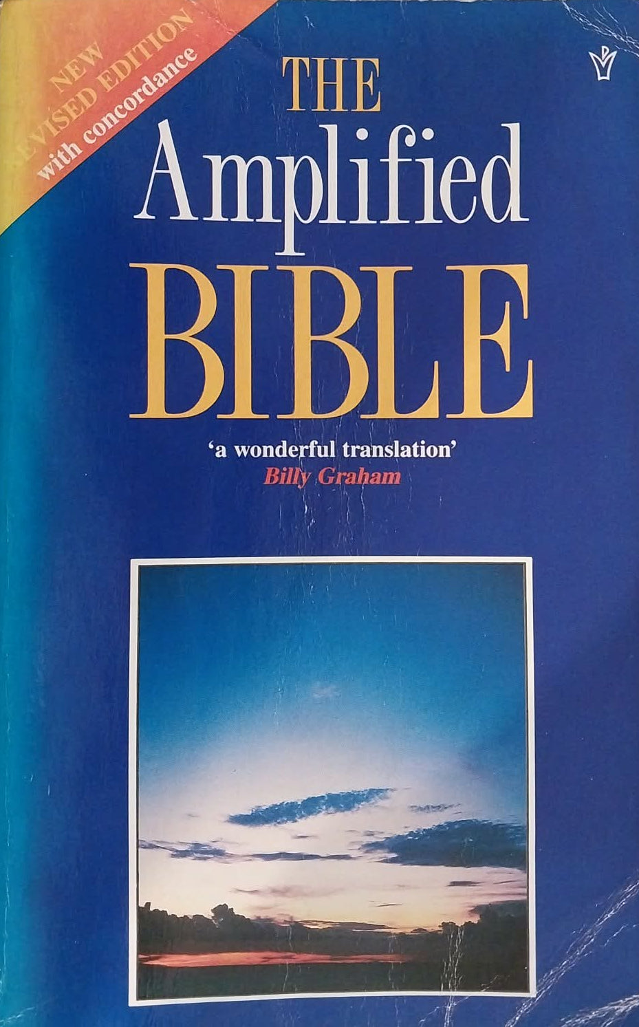 The Amplified Bible book cover, featuring a blue background with gold and white lettering and a small landscape photograph near the bottom.