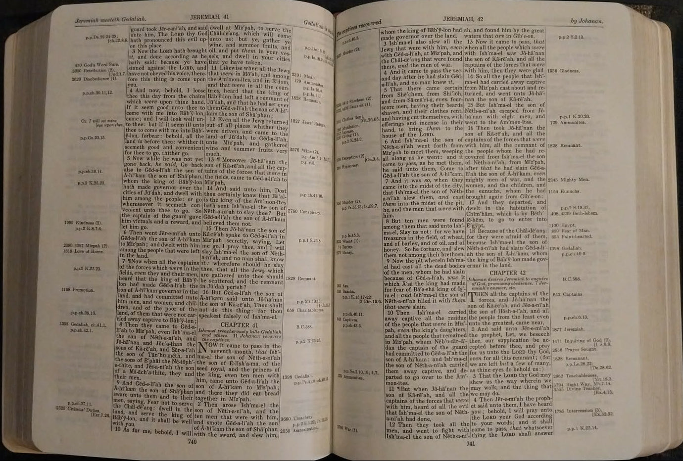 Open book with text on a dark surface