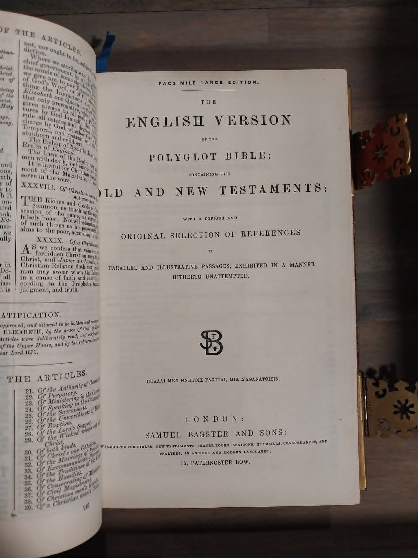 An open antique book showing the title page of 'The English Version of the Polyglot Bible: Old and New Testaments' on aged white paper, photographed on a dark wooden surface.