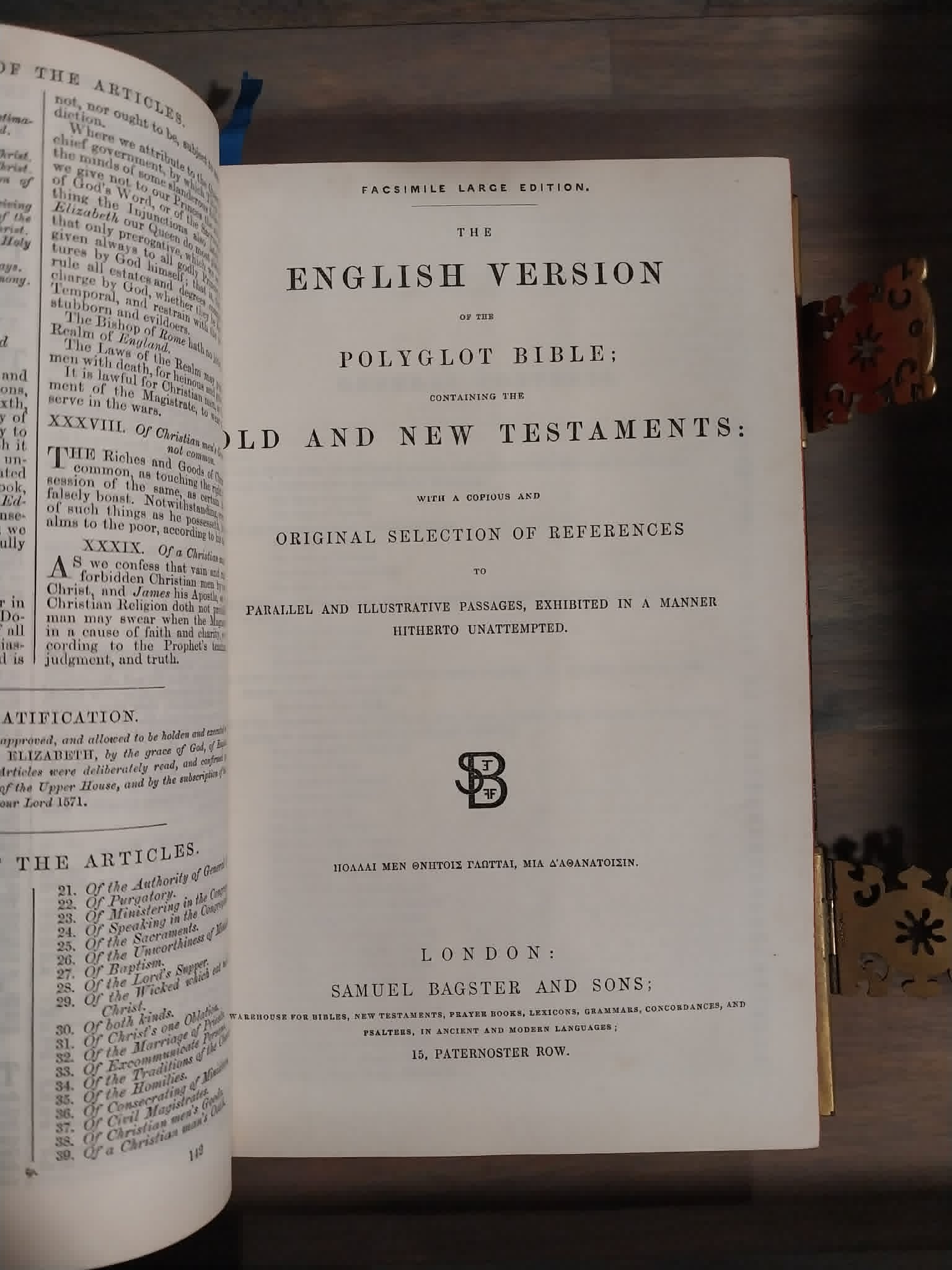An open antique book showing the title page of 'The English Version of the Polyglot Bible: Old and New Testaments' on aged white paper, photographed on a dark wooden surface.