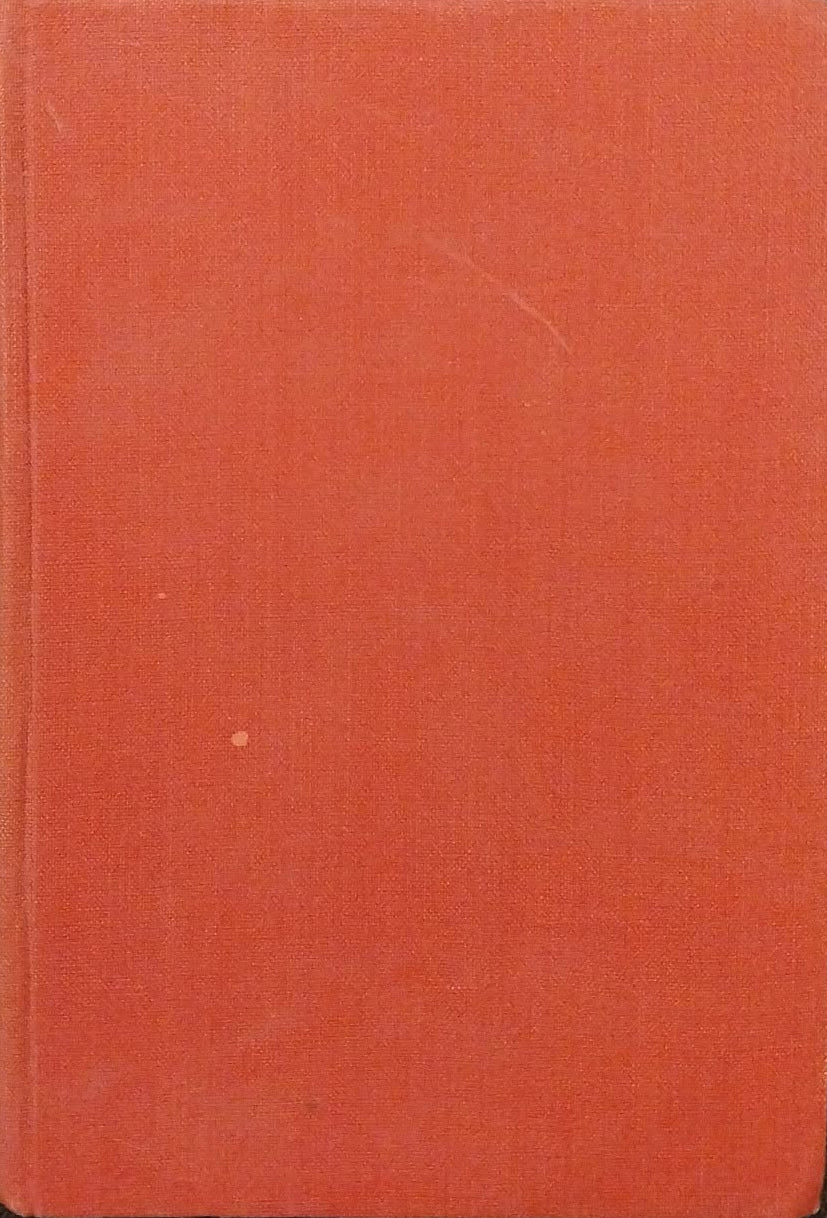 Red book on a dark surface with a ruler in the background