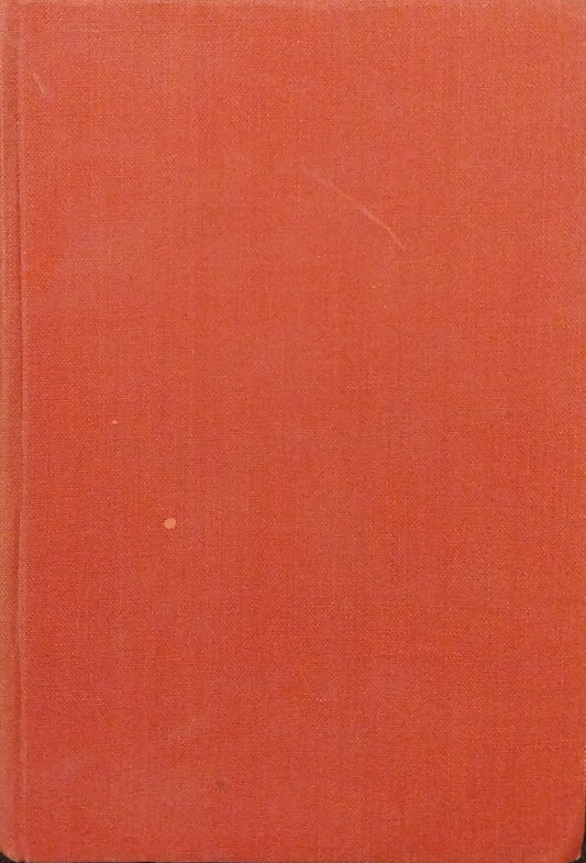 Red book on a dark surface with a ruler in the background