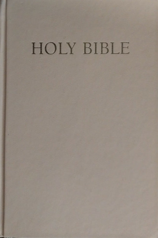 A classic Holy Bible with a plain off-white cover and the words 'HOLY BIBLE' printed in black serif text at the top, shown against a dark background.