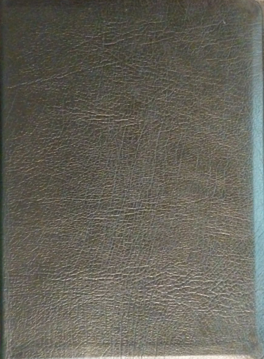 Black leather-bound book on a textured surface