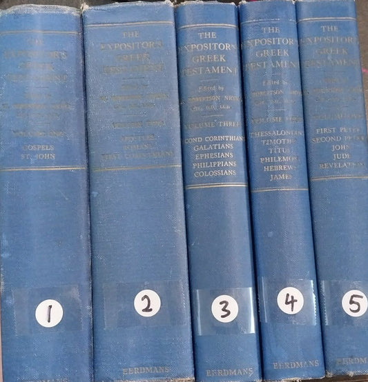Set of five blue books stacked on a dark surface
