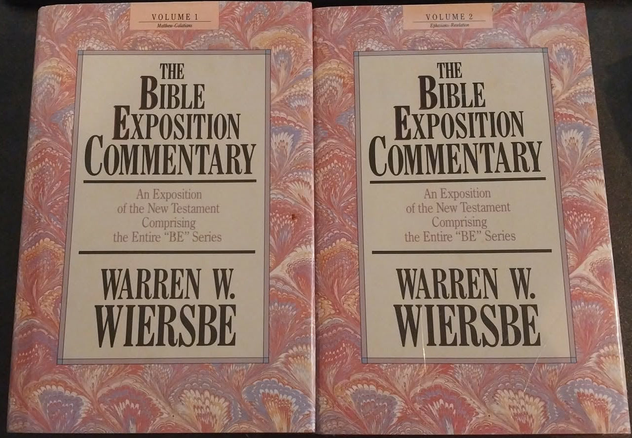 Two books titled 'The Bible Exposition Commentary' by Warren W. Wiersbe on a dark surface.