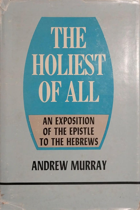 A vintage paperback book titled 'The Holiest of All' by Andrew Murray, featuring a light blue-gray cover with a prominent teal-blue central shield and cream text, photographed on a beige surface.