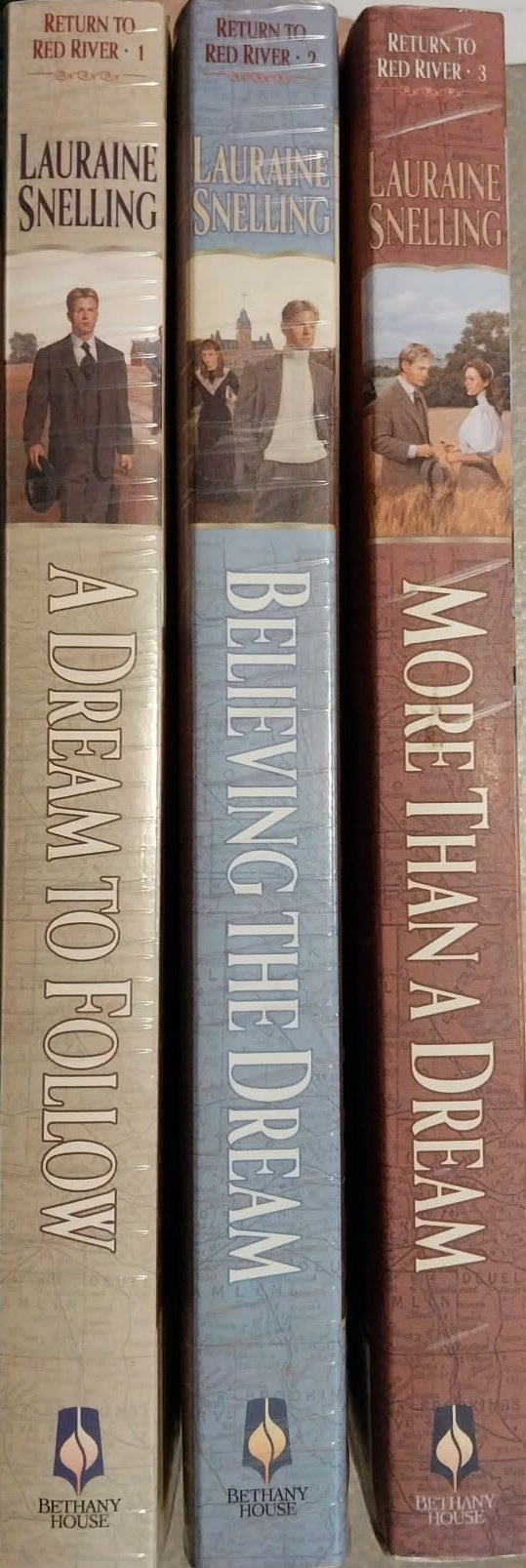 Three books titled 'A Dream to Follow', 'Believing the Dream', and 'More Than a Dream' by Lauraine Snelling on a gray surface.