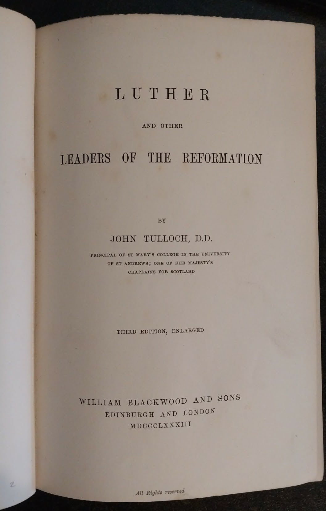 An open vintage book showing the title page for 'Luther and Other Leaders of the Reformation' by John Tulloch, D.D.